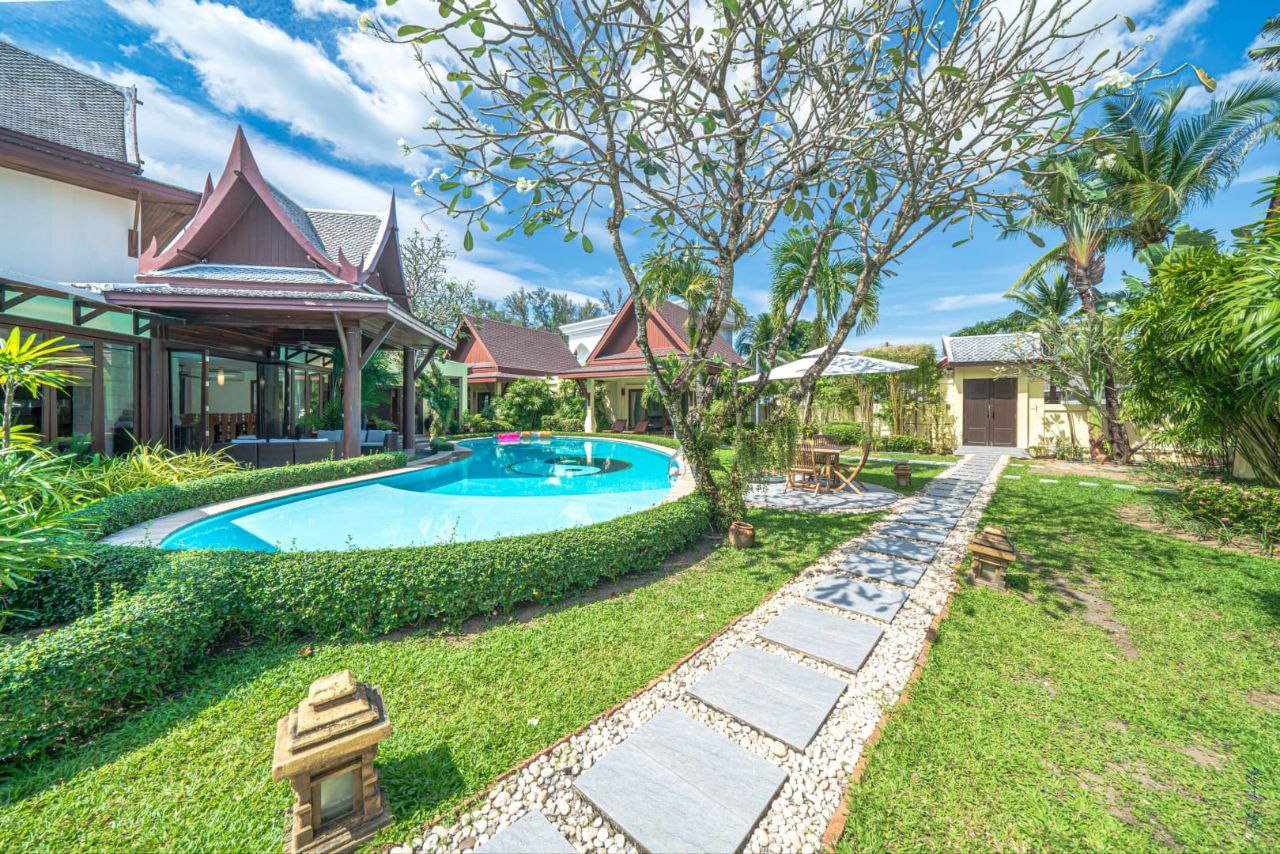 Luxury pool and garden with traditional Thai architecture at The Himmaphan Phuket villa.